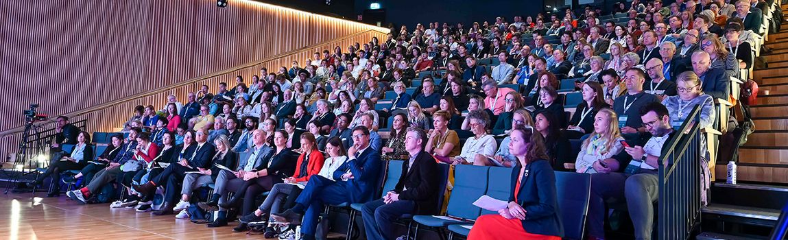 large group of people in tiered seating at the Walk21Ireland conference