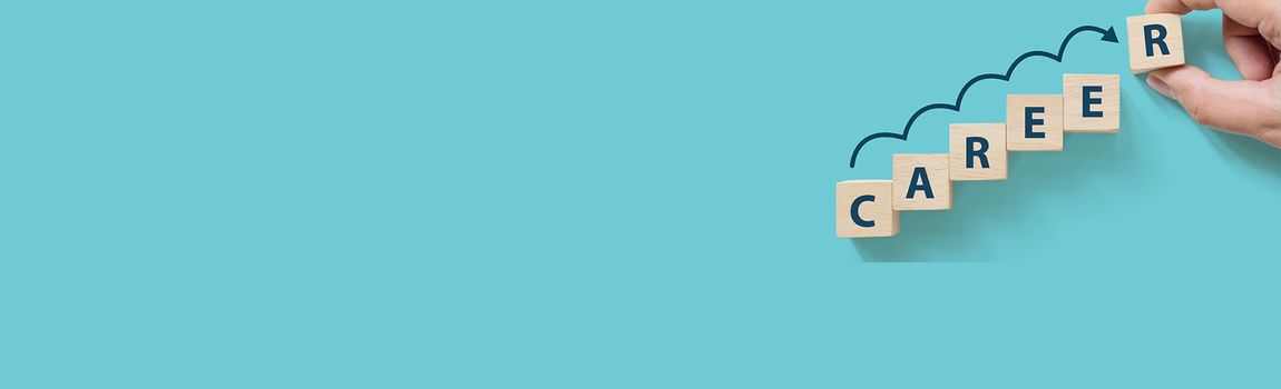 Hand putting wooden cube block on blue background with word CAREER and copy space for your text. Business career planning growth to success concept