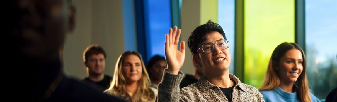 postgraduate student asking question in classroom