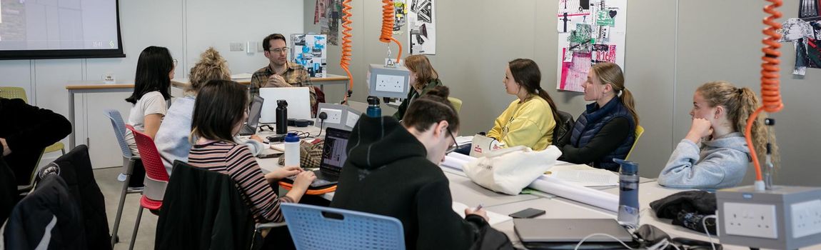 Students in design class around a table