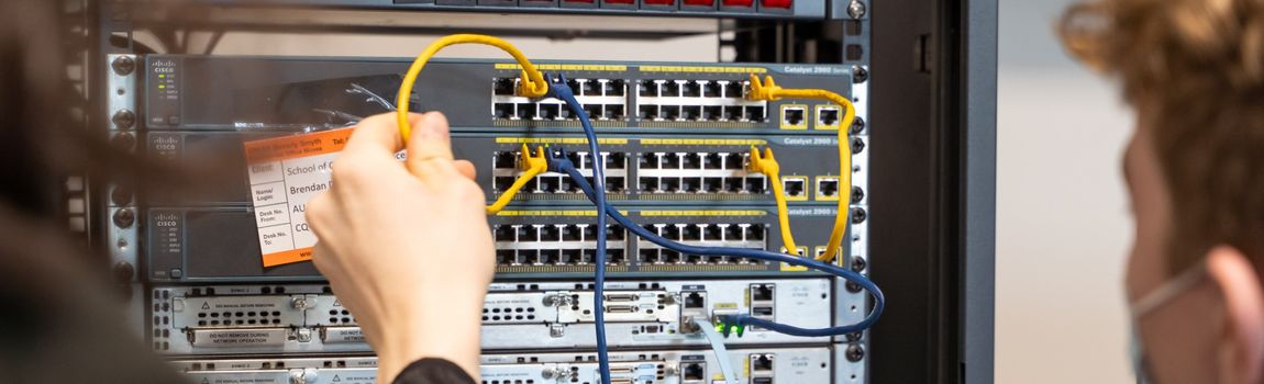 A student working with a Computer Networking Router