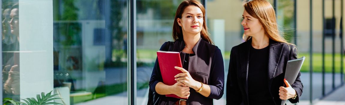 Two Law students walking with books in their hand