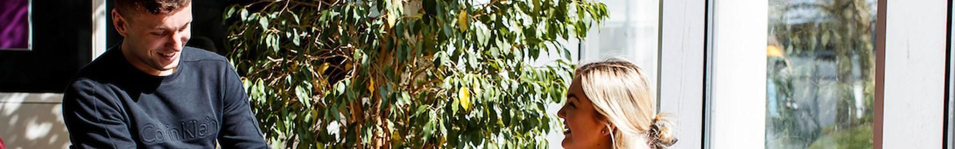 Students sitting and chatting indoors on campus