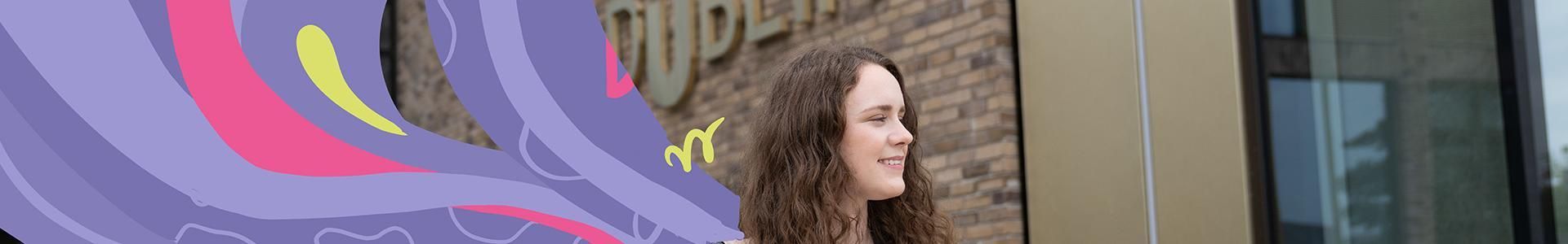 student walking tu dublin brass sign east quad