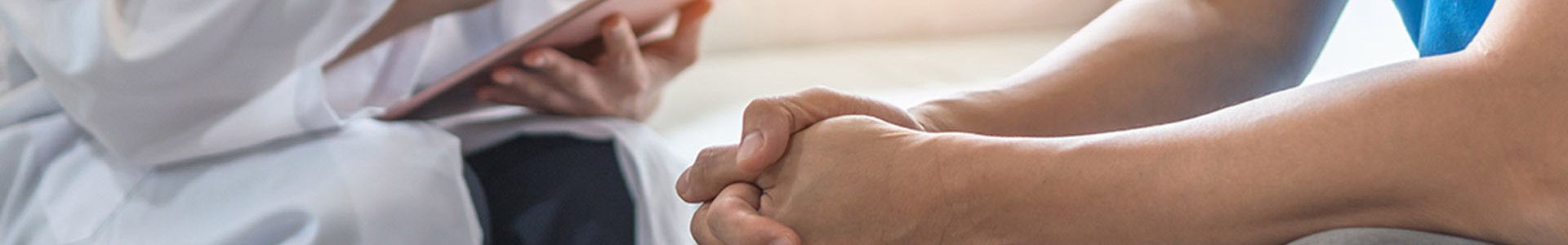 doctor with clipboard discussing with a patient