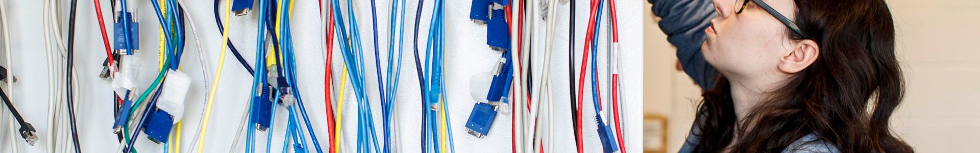 computer networking student working with coloured wires