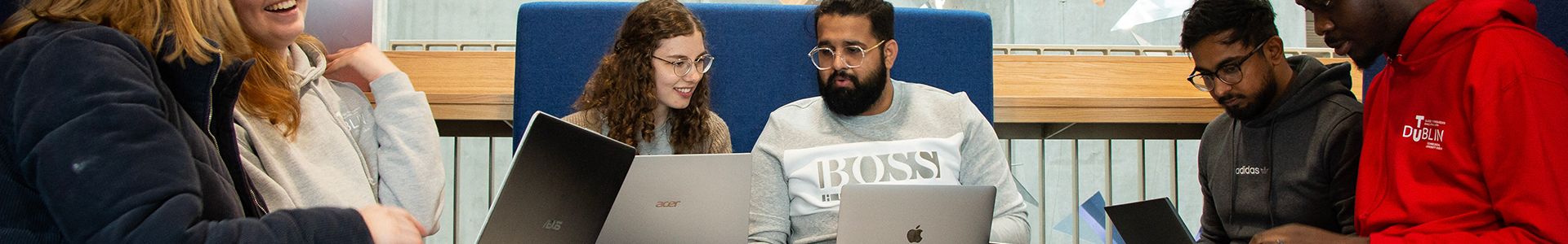 Group of students working together on laptops