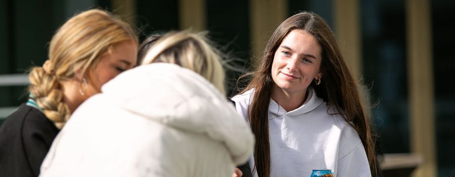 girl sitting outdoors talking to friends