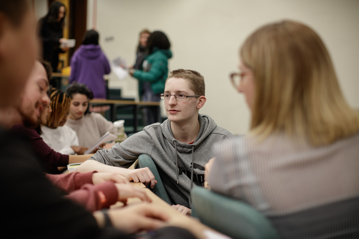 Students conversing in a lecture hall
