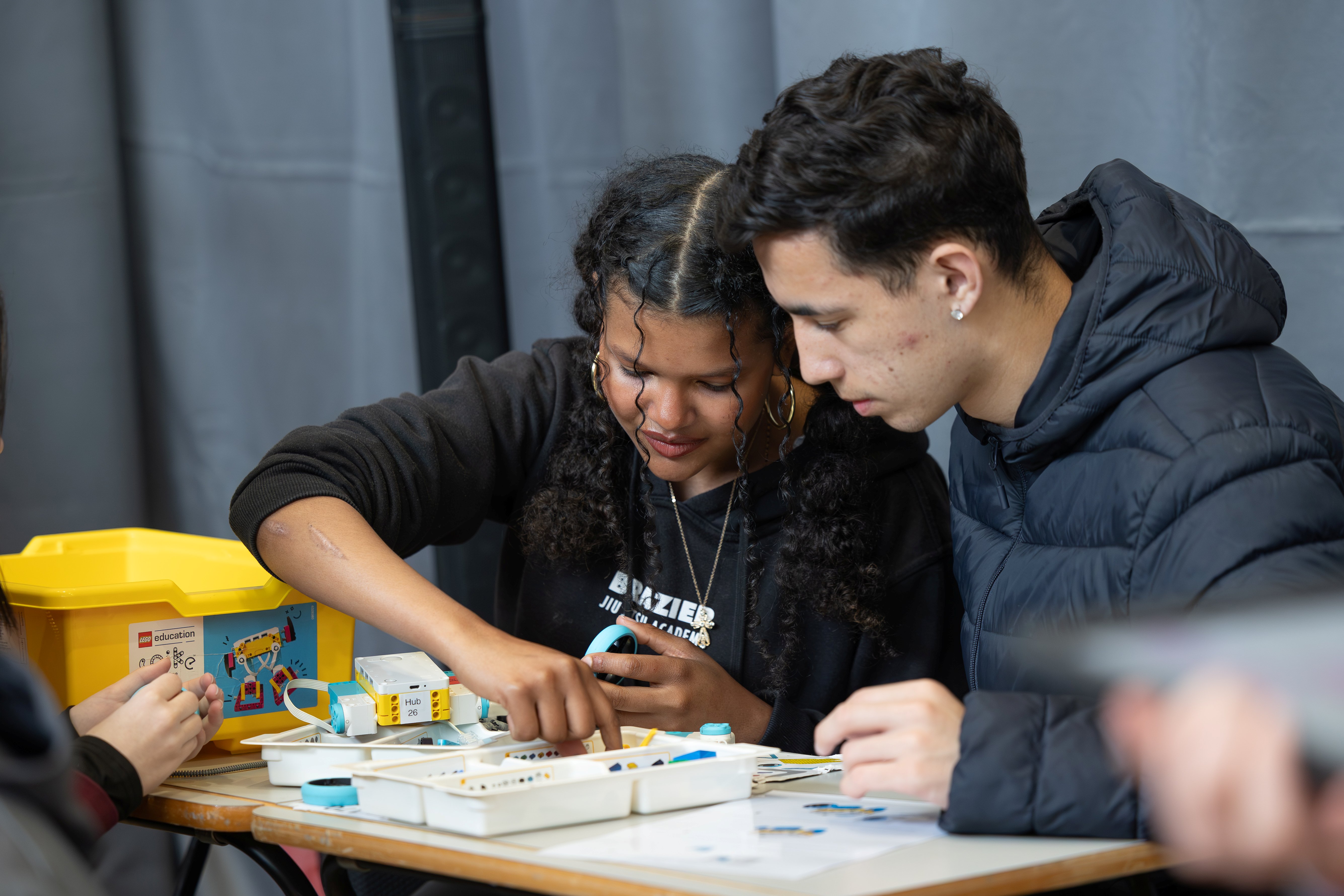 Two students working together on a robotics project.