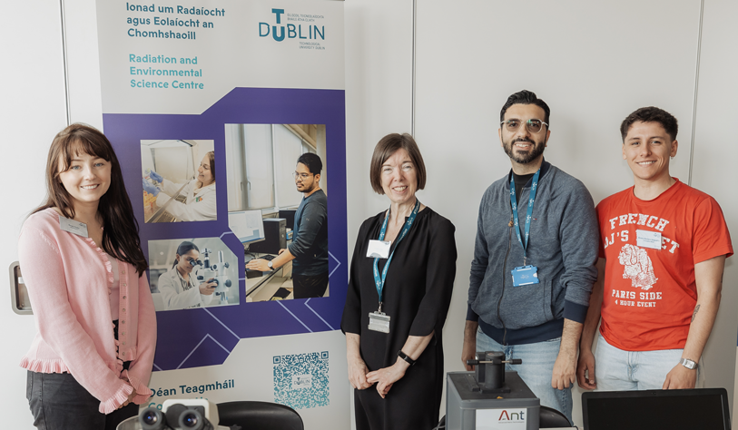 Three researchers from Radiation lab at a exhibit table