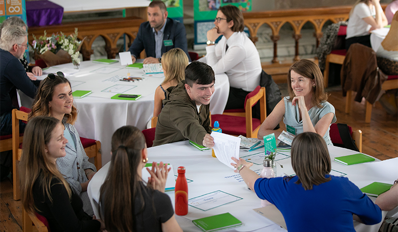 People sitting around table in discussion