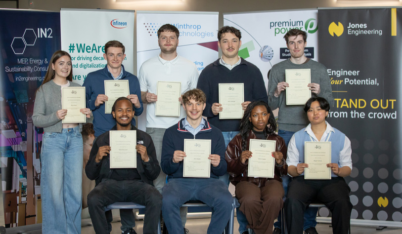 Students holding up their awards