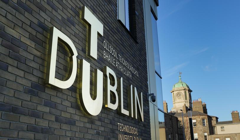 An image of the TU Dublin logo with the clock tower in grangegorman in the background
