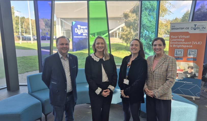 Four people standing together at TU Dublin’s Blanchardstown Campus, with TU Dublin and Brightspace signage visible in the background.