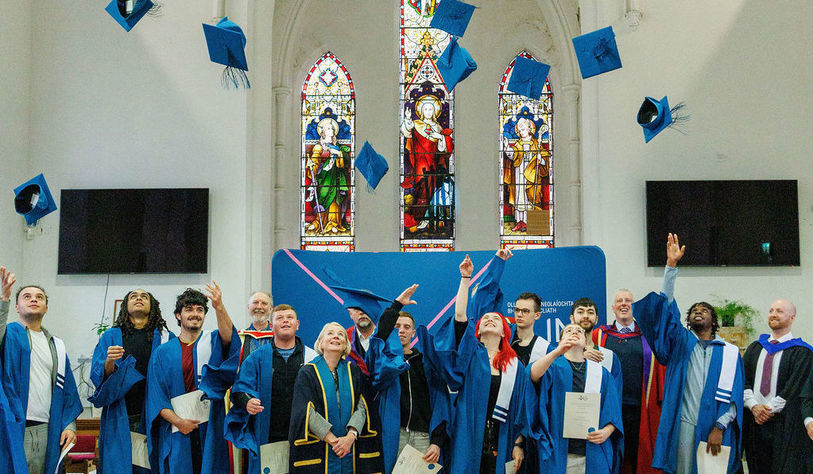 Students throw their Mortar Boards in the air