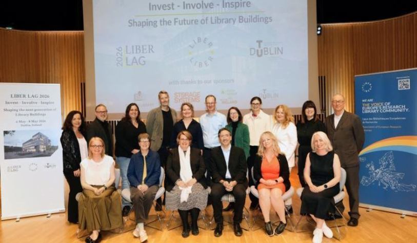 A group of people pose in front of a large banner that says LIBER LAG Seminar,
