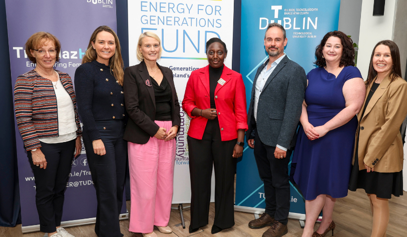 Seven people pose for a group photo at the TU Dublin and ESB TrailblazHER Scholarship launch, standing in front of TU Dublin and ESB “Energy for Generations Fund” branding.