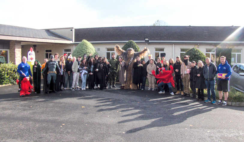 A group of people in costumes pose for a photo