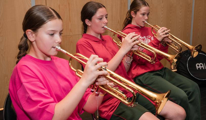 Young people playing brass instruments
