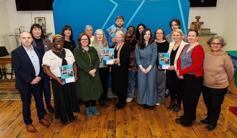 A large group of people celebrating an EDI strategy launch