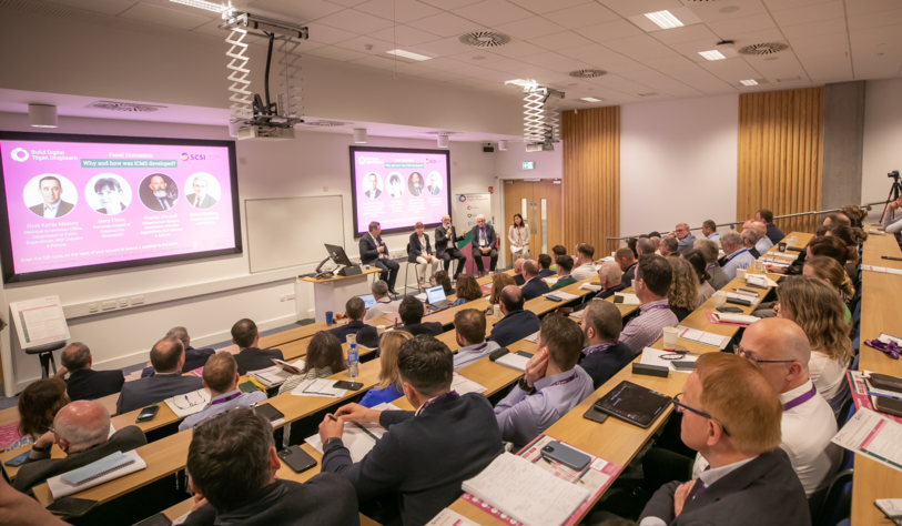 A group of people at an event in a lecture hall